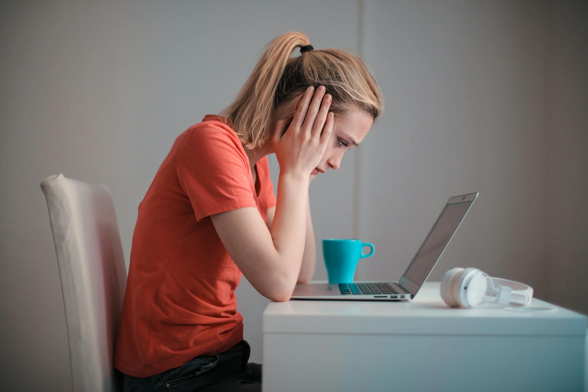 young troubled woman using laptop at home